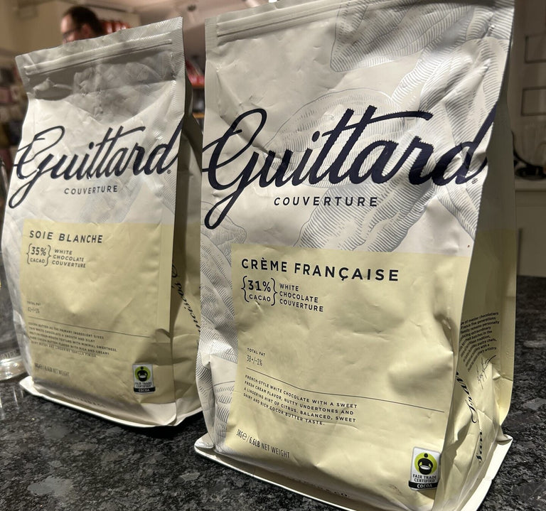 Two Guittard Couverture chocolate bags on a kitchen counter.