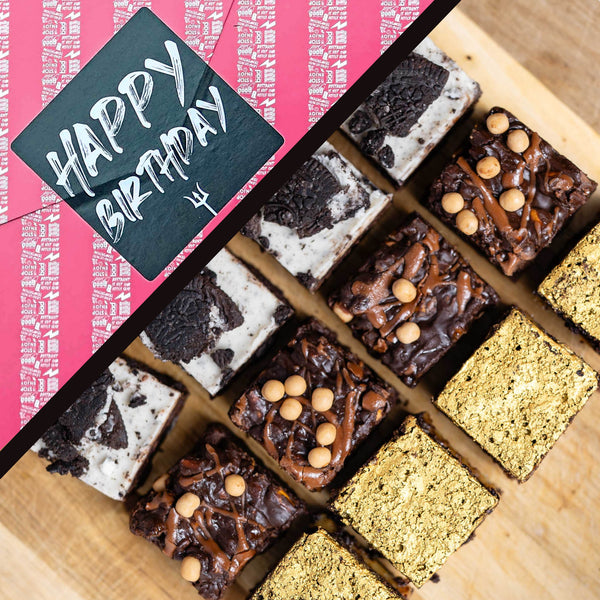 LIMITED EDITION Cosy Cravings Brownie Box in Happy Birthday gift wrap. A styled flat-lay of assorted chocolate brownies arranged on a wooden board, with a pink gift wrap reading “HAPPY BIRTHDAY