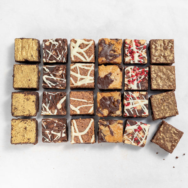 A selection of chocolate brownies with various toppings and fillings, arranged in a grid pattern to represent a box of 24 bites.