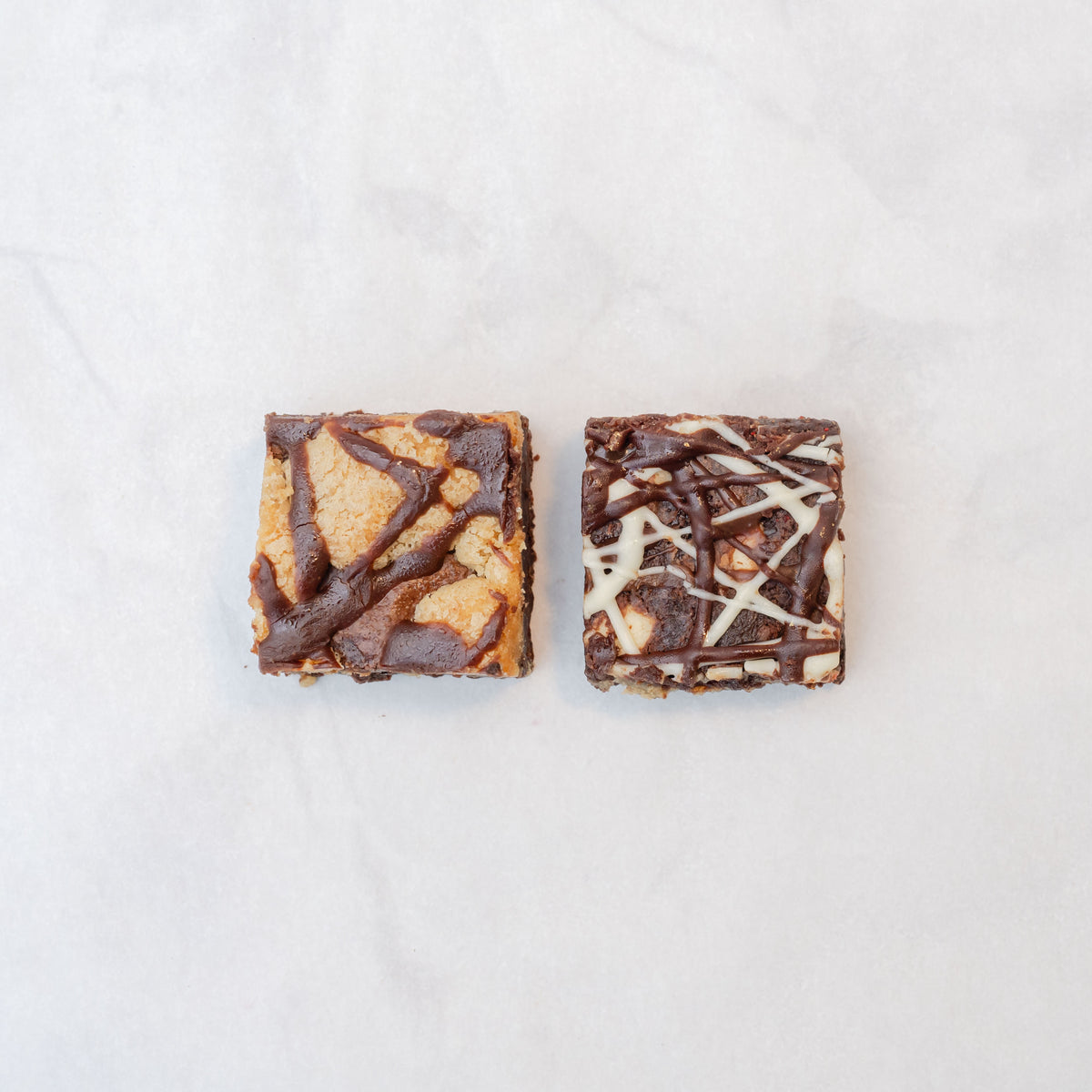 chocolate brownie brookie and triple chocolate brownie on pale background