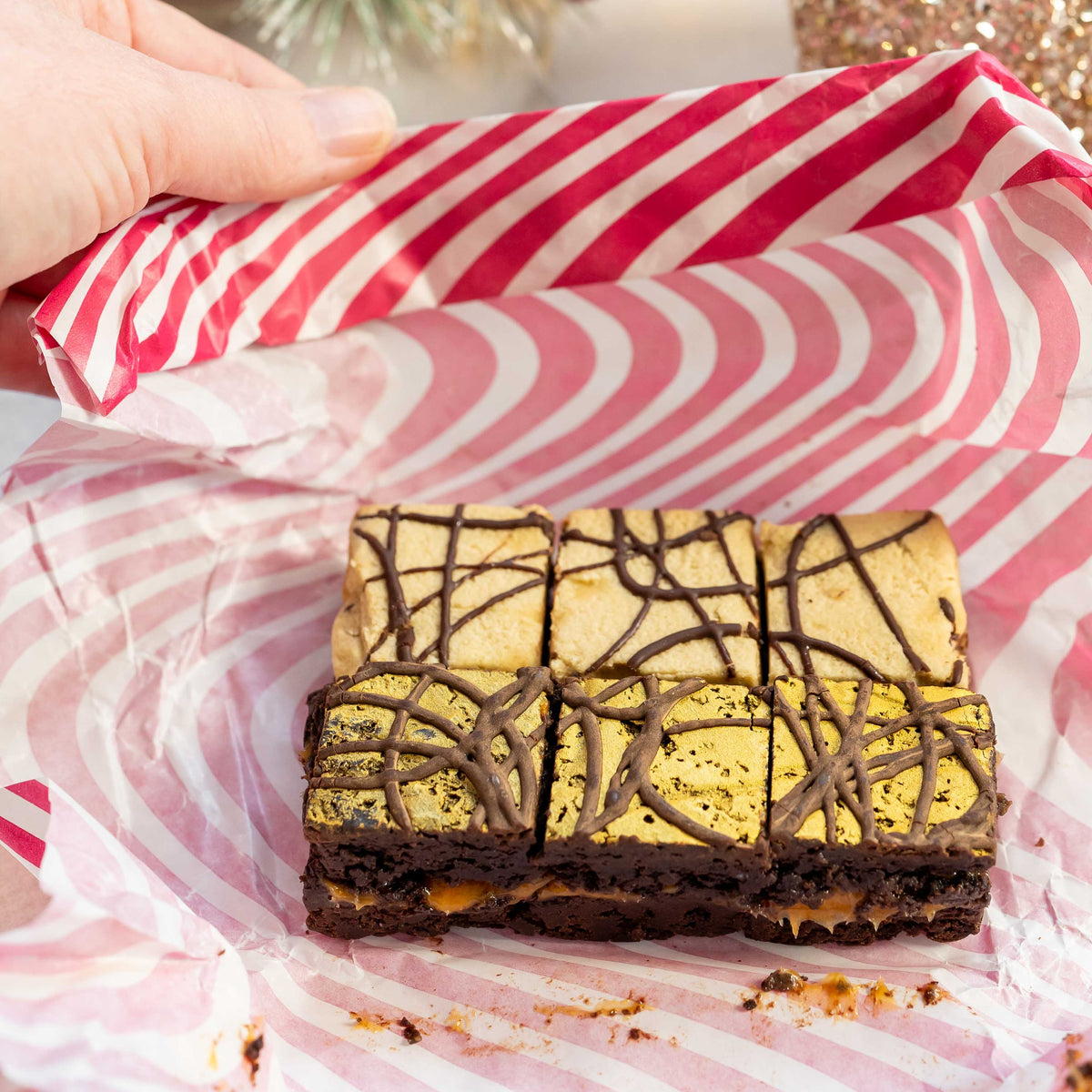 Vegan gluten free chocolate brownies in pink and white striped paper