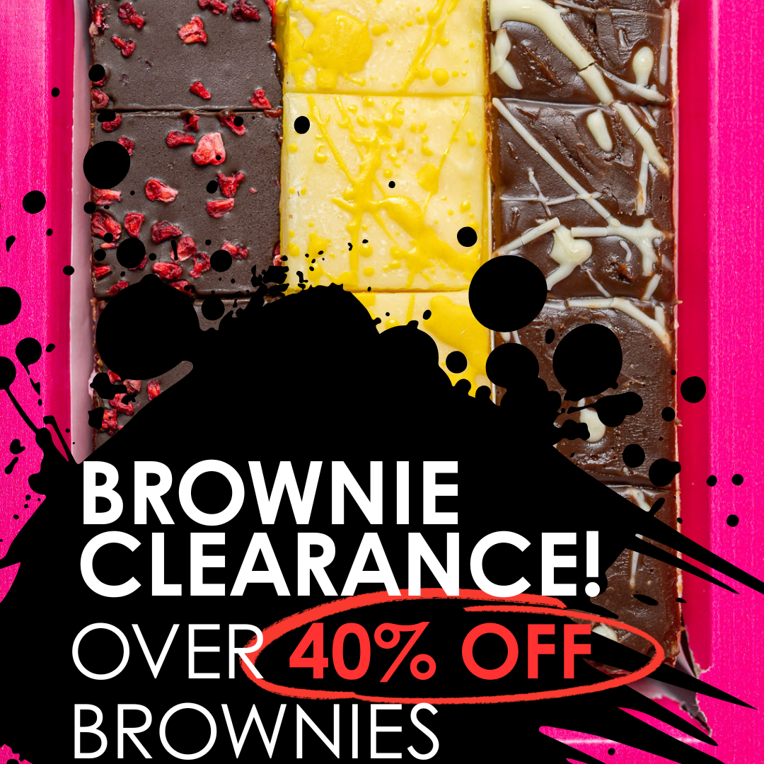 A promotional graphic for a brownie clearance sale showing a boxed assortment of chocolate brownies in a bright pink container. The brownies are arranged in a grid with three vertical sections: dark chocolate with red dried fruit, pale yellow chocolate, and dark chocolate with white drizzle.