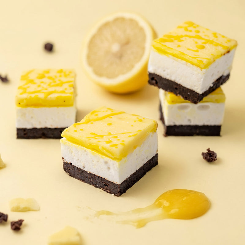 Lemon-flavored marshmallow chocolate brownie with a lemon and chocolate pieces on a yellow background