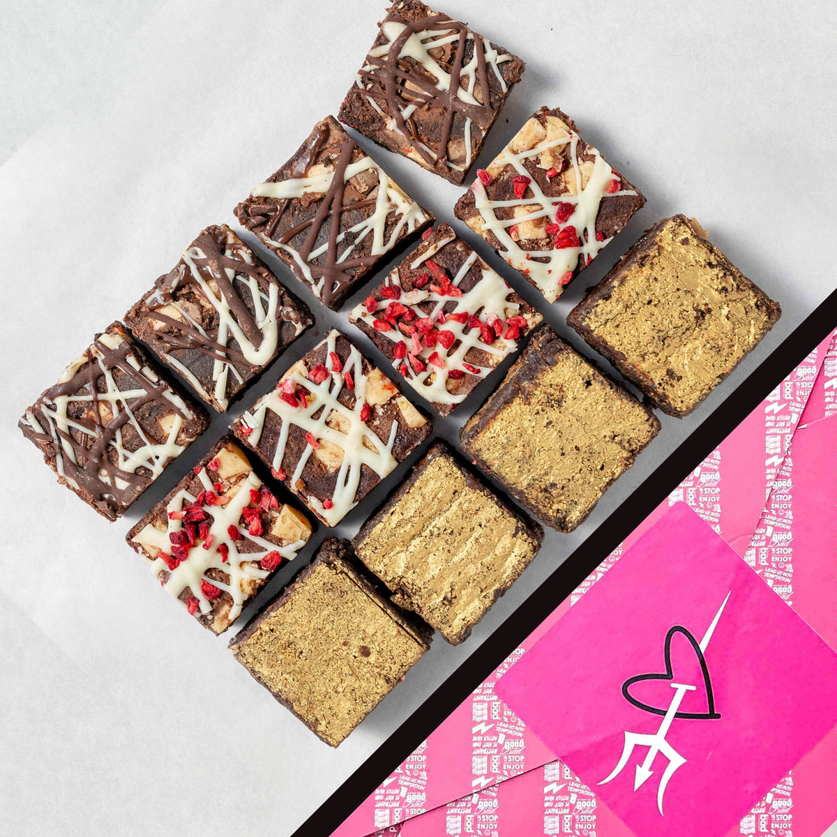 Assorted brownies in a box with a pink and white design on a light gray background