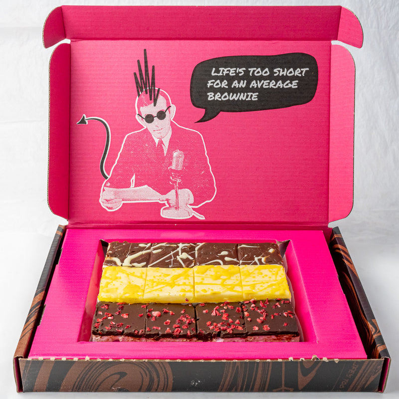 Open pink postal brownie box with various brownies and a graphic of a person with a mohawk and sunglasses.
