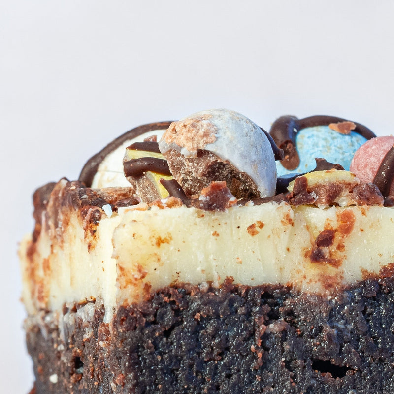 mini egg chocolate brownie close up showing mini eggs, white chocolate ganache and brownie layers
