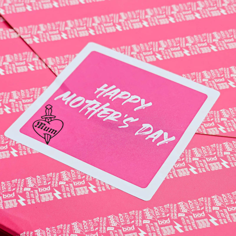 pink bad brownie gift wrap sticker  with text saying Mothers Day and a white border on a pink gift wrap