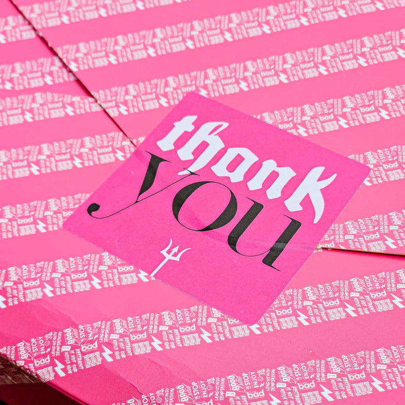 Pink sticker with 'thank you' text on a matching pink background